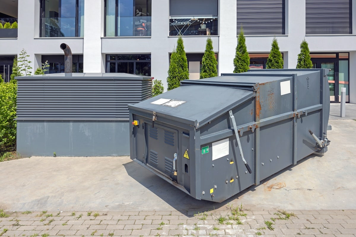 Waste compactor placed outside of a place of business